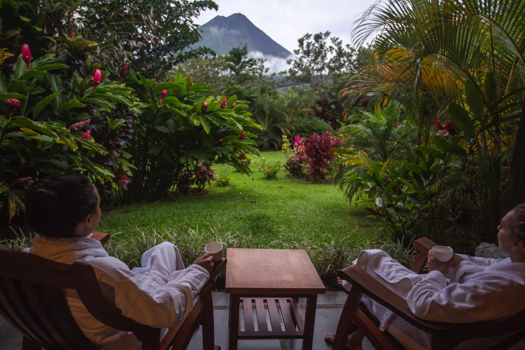 Volcano Chat Travellers sharing a sip of coffee and conversation with Arenal in view
