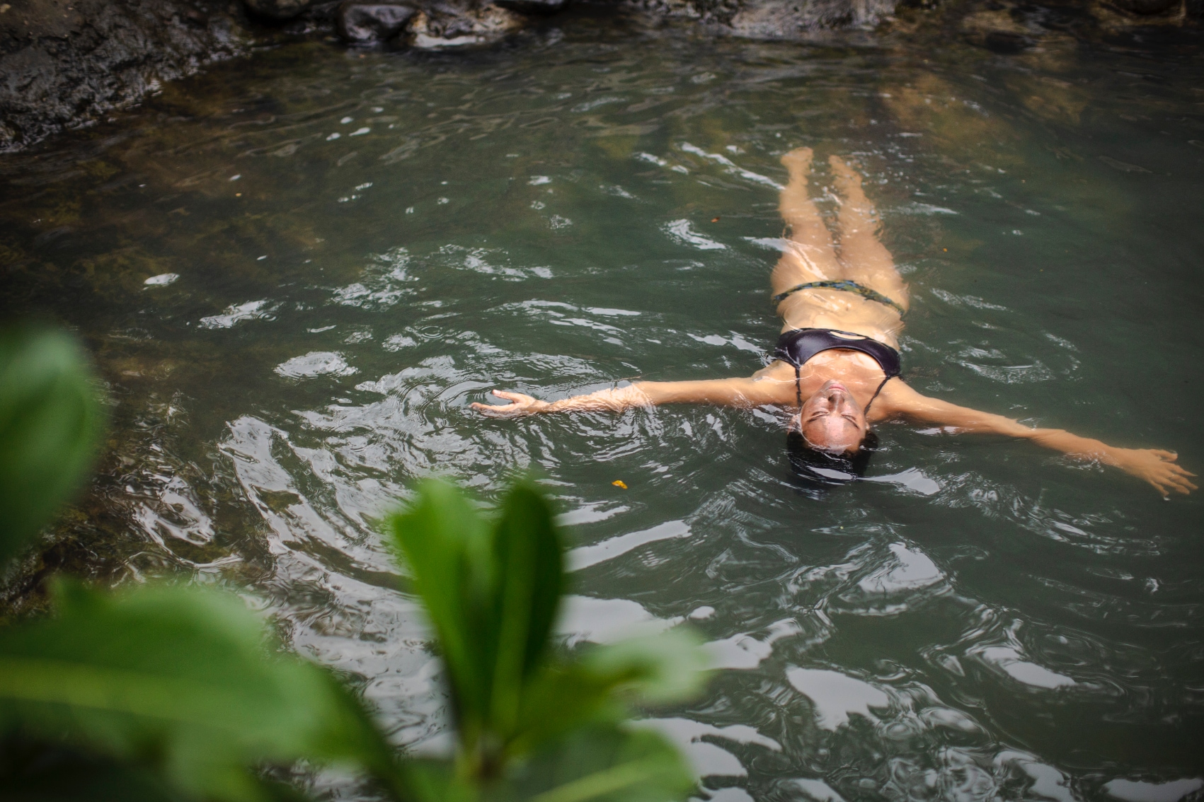 Hot springs floating a solo female traveller floats peacefully in Costa Rica hot springs