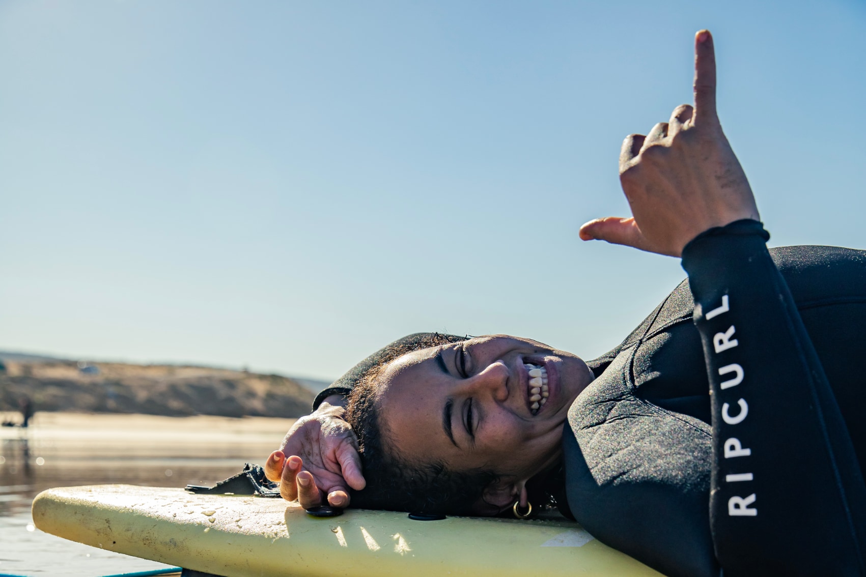 Taghazout Beach surfer A traveller learning to surf in Taghazout throws a shaka