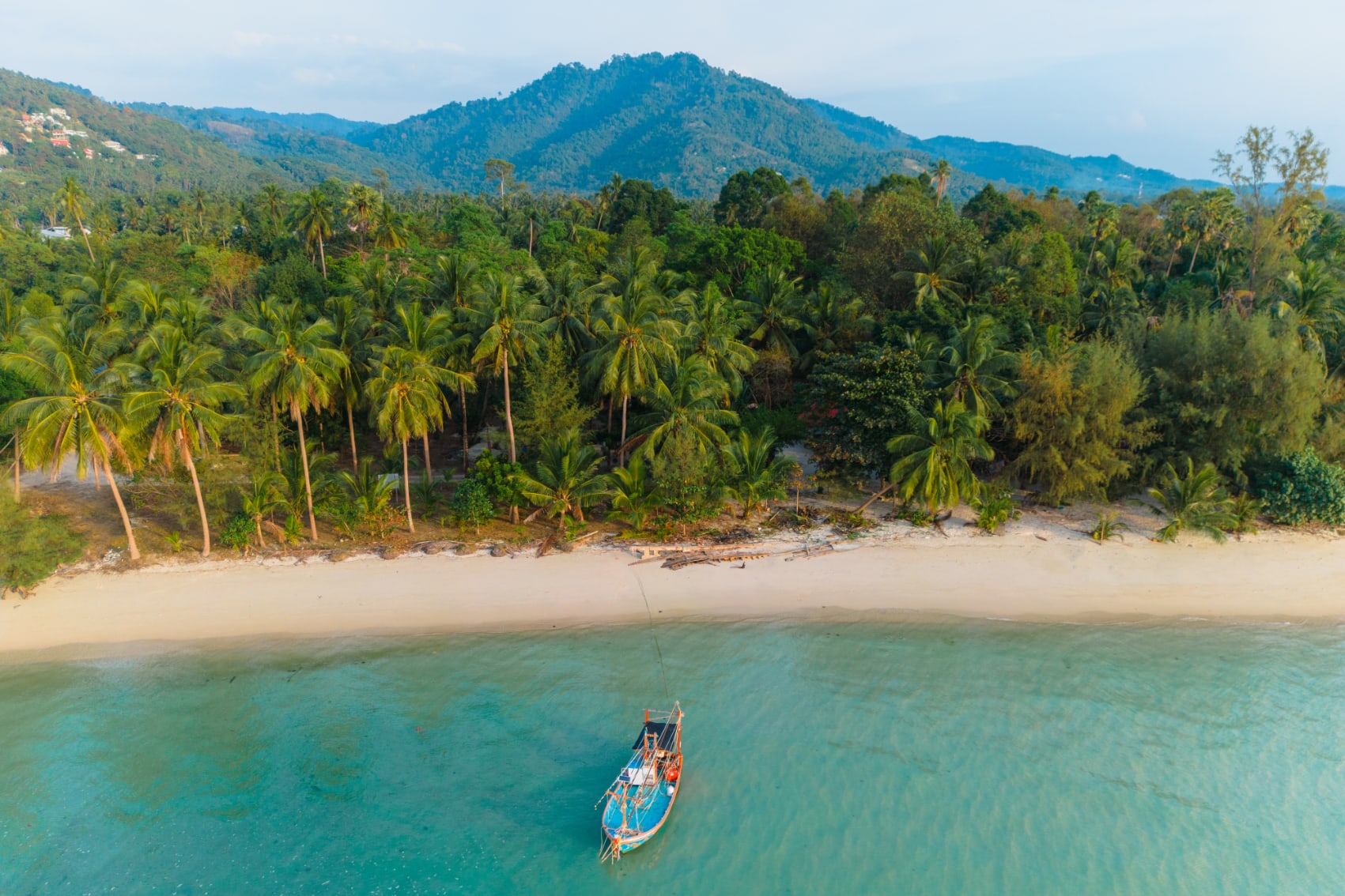 koh samui beach boat a traditional boat floats in the crystalline waters off Koh Samui island, Thailand