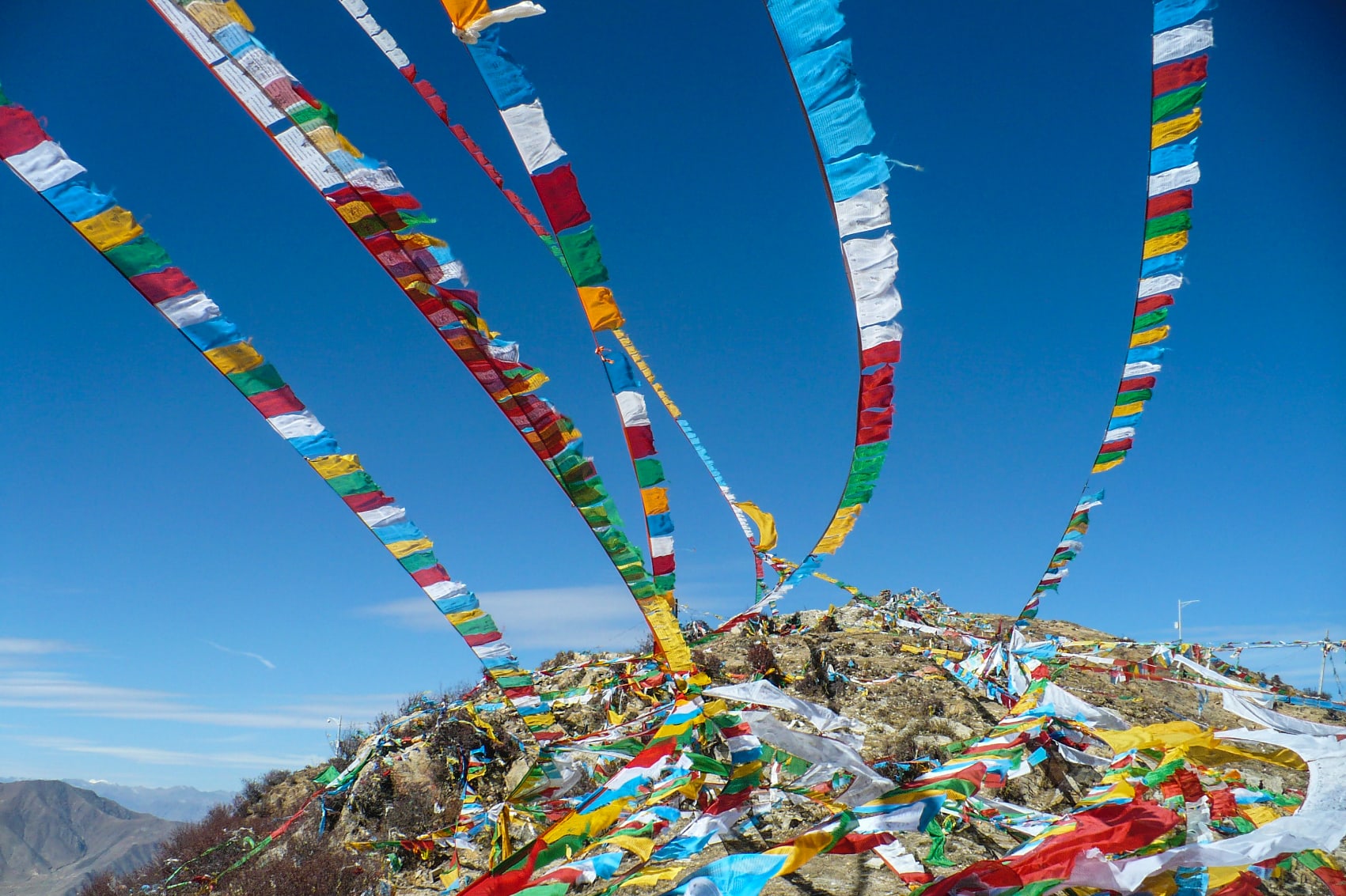 tibetan prayer flags colourful Tibetan prayer flags stream from atop Himalayan mountains
